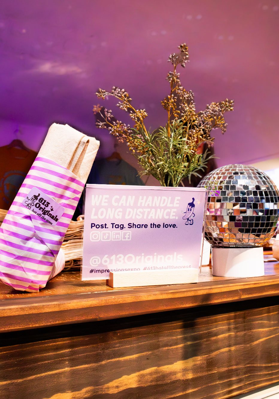 A close up of our Thankful Burrito and a sign that says "We can handle long distance. Like. Post. Share the Love. @613originals"