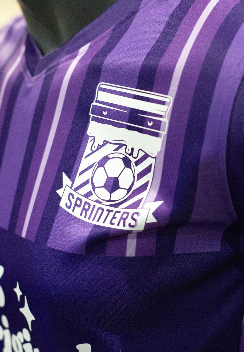 A close up of a logo on a purple jersey. Reads "Sprinters"